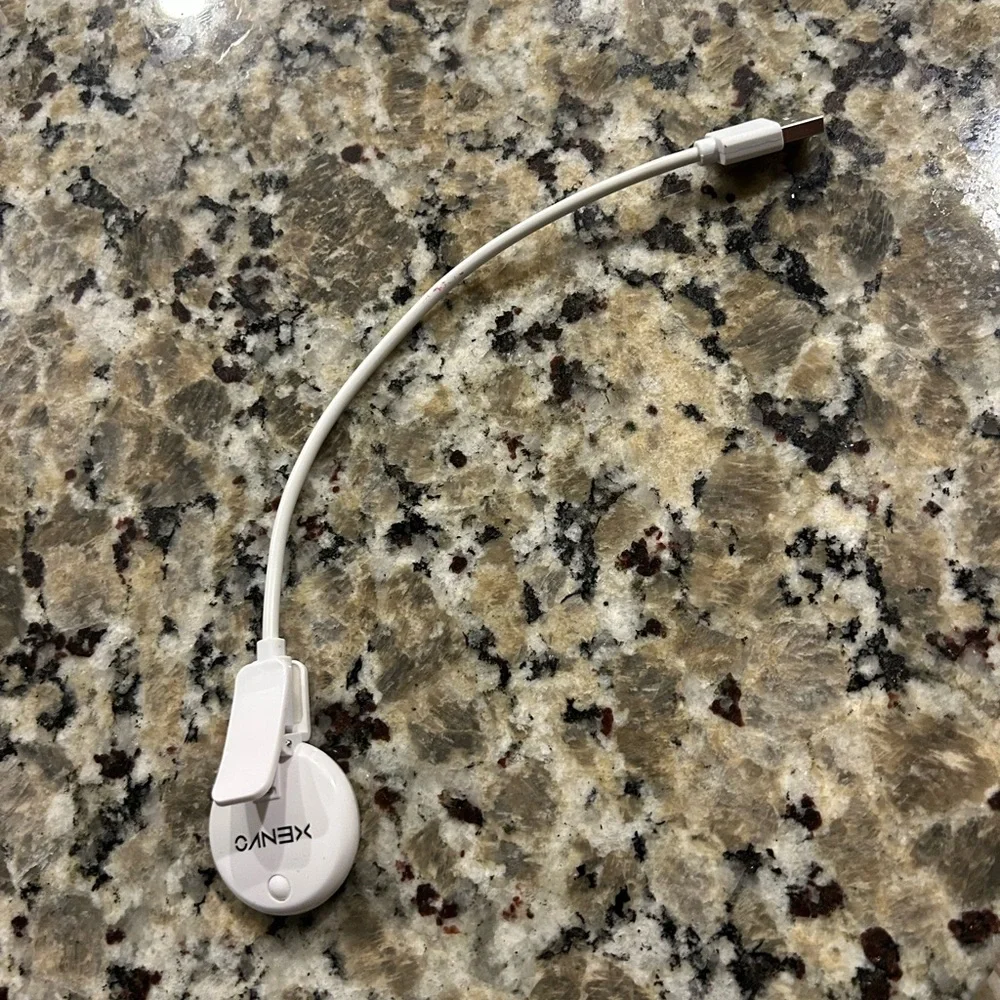 White Mini phone light with clip and  Charging Cable